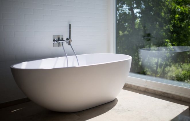 Bathtub Beside Glass Wall — Expert Plumbers in Palm Beach, QLD